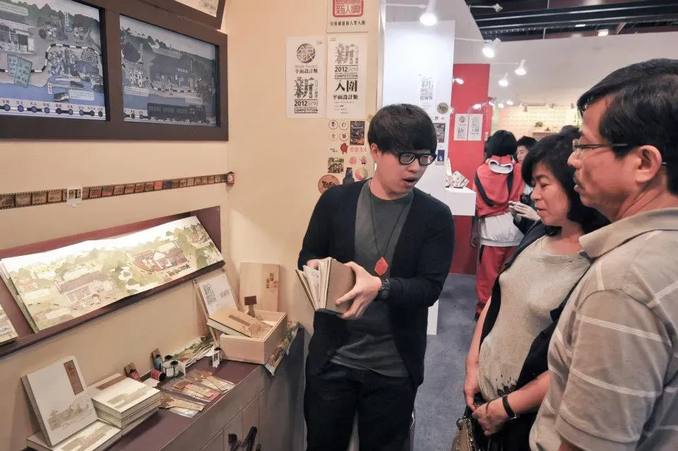 在新一代設計展的畢業製作展位向參觀者介紹作品